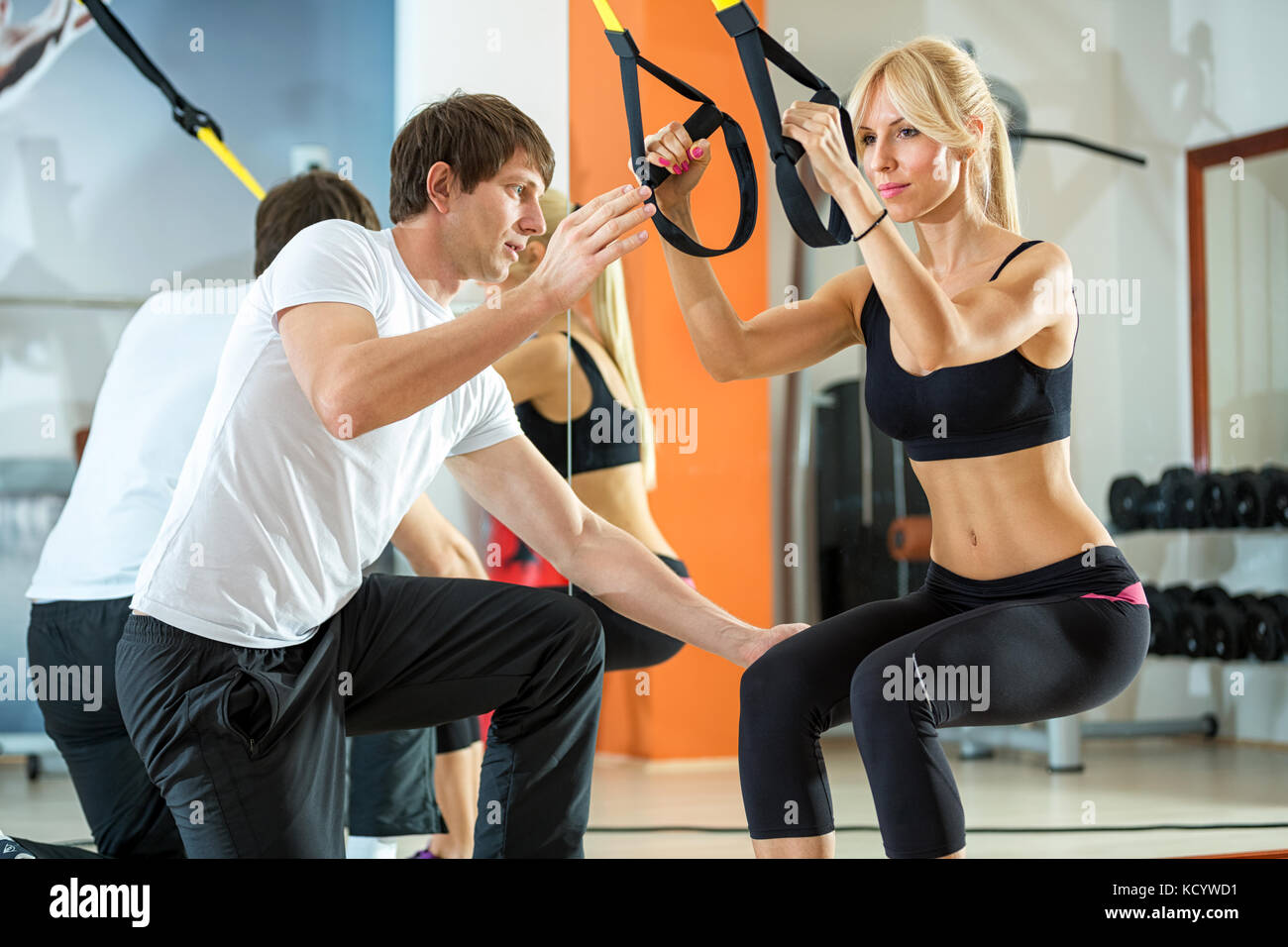 attractive woman doing suspension training with fitness straps Stock Photo