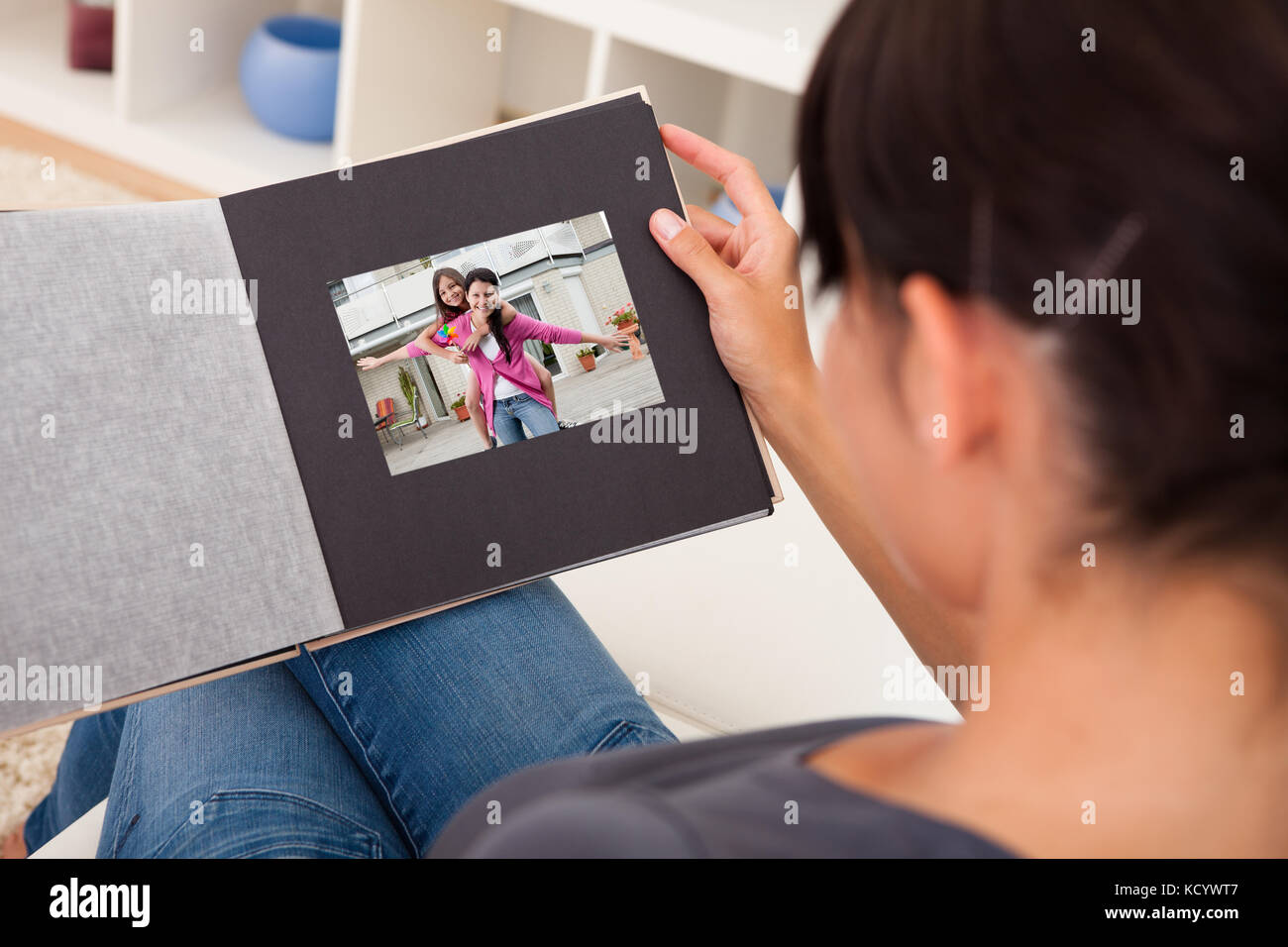 Woman looking at photo album hi-res stock photography and images
