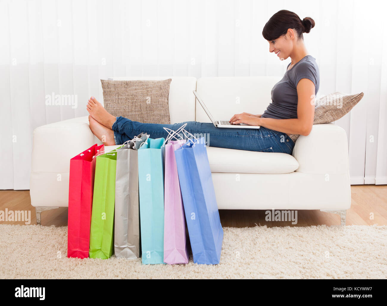 Young Beautiful Woman Sitting On Couch Shopping Online Stock Photo Alamy