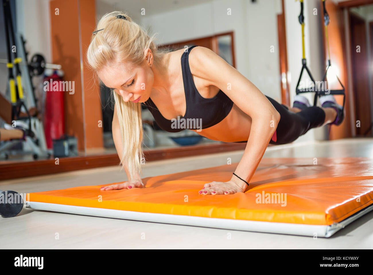 fit woman in fitness salon in push up pose exercise Stock Photo