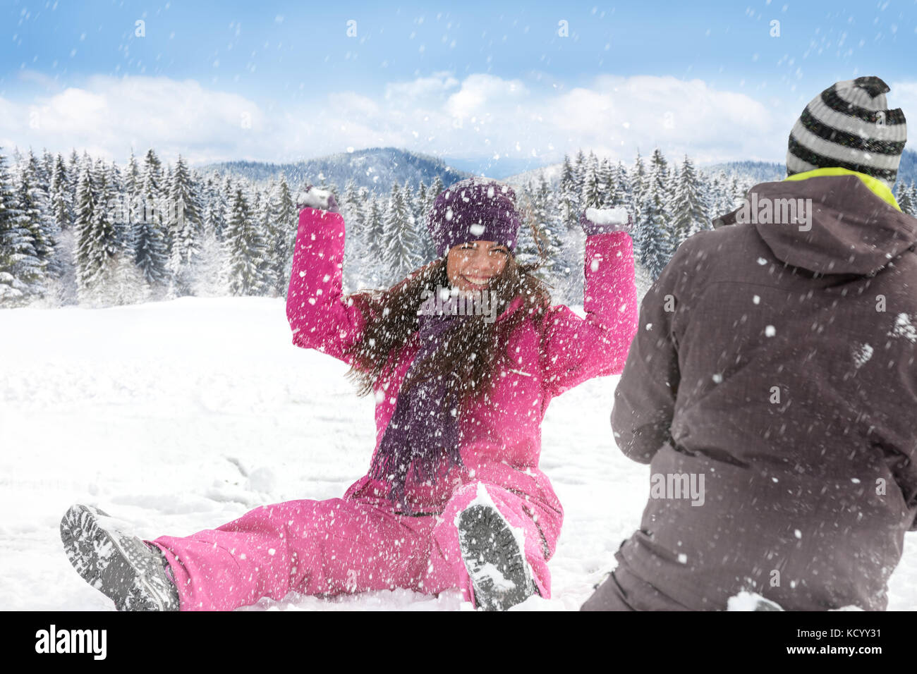 Winter couple having fun playing in snow outdoors, snowball fight Stock ...