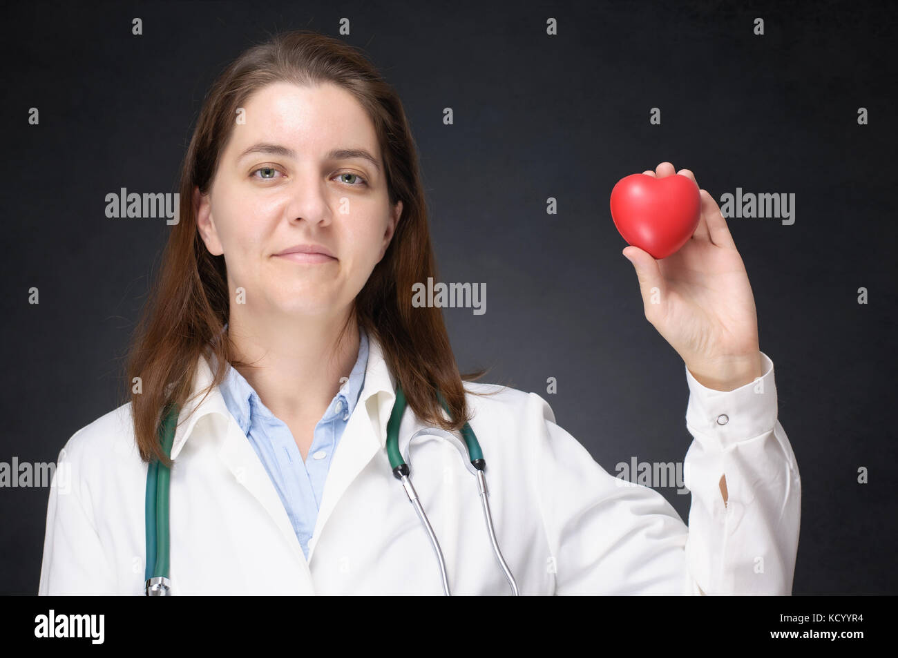 Female doctor holding a red heart shape Stock Photo - Alamy
