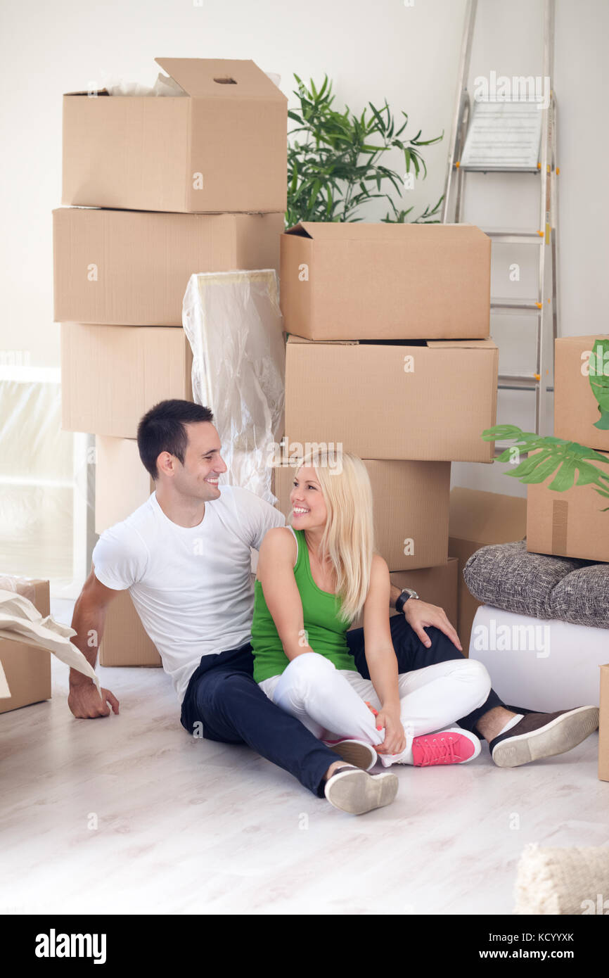 Young couple resting from moving into a new home Stock Photo - Alamy