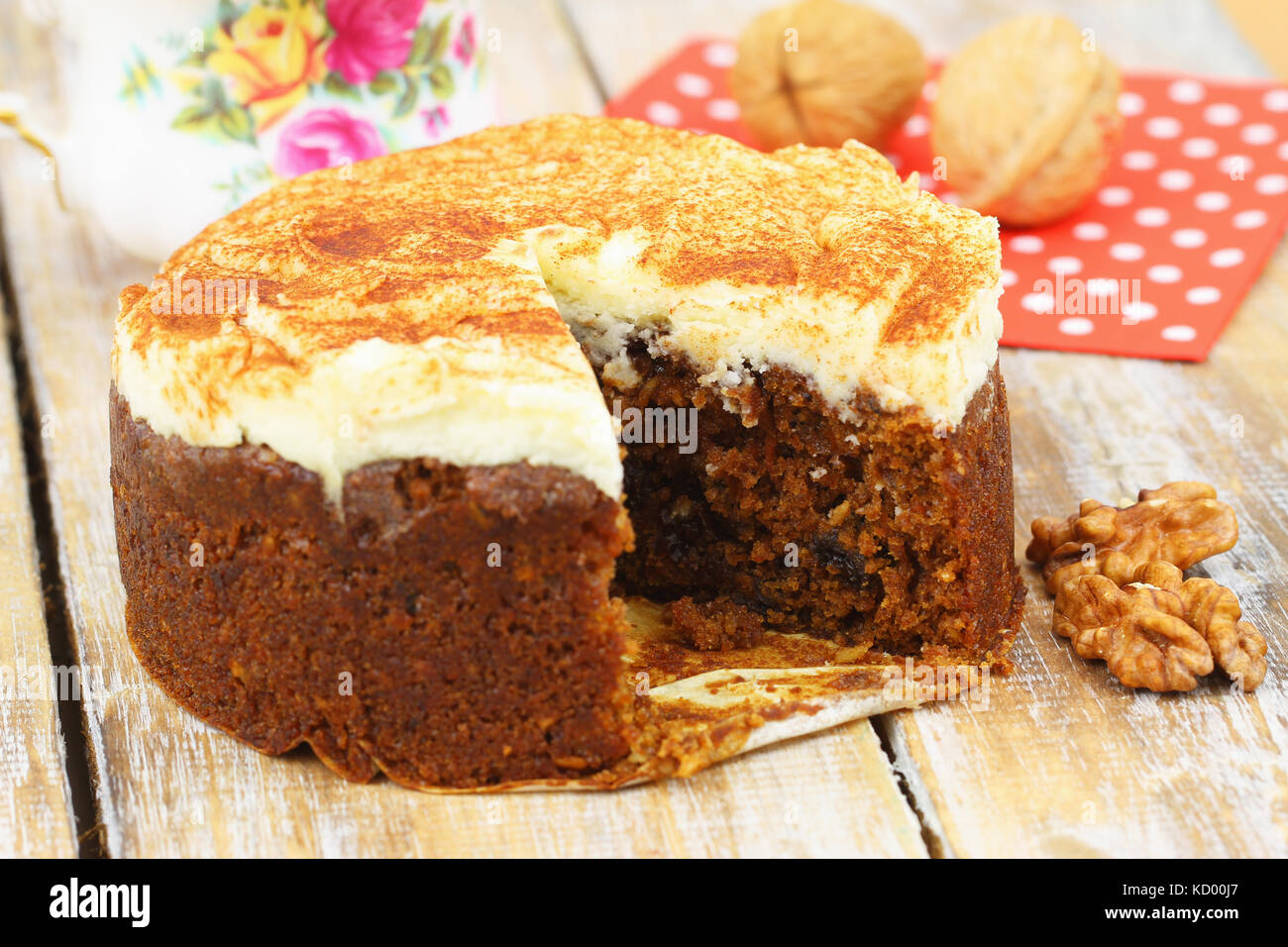 Delicious walnut and carrot cake with marzipan icing on rustic wooden surface Stock Photo
