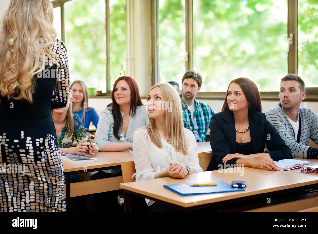 group-of-students-listening-to-teacher-in-classroom-stock-photo-alamy