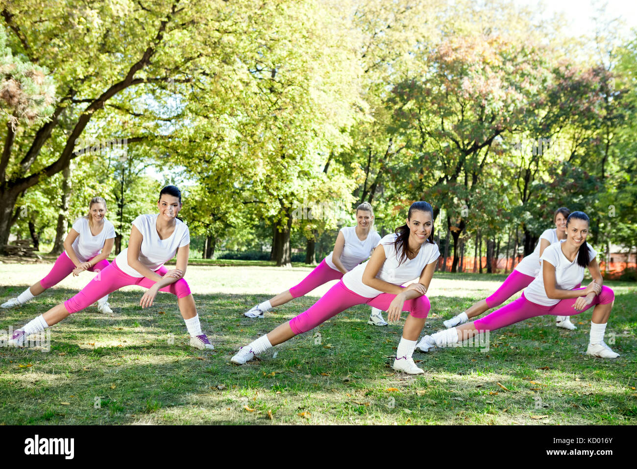 Group of six woman stretching legs, outdoor Stock Photo - Alamy