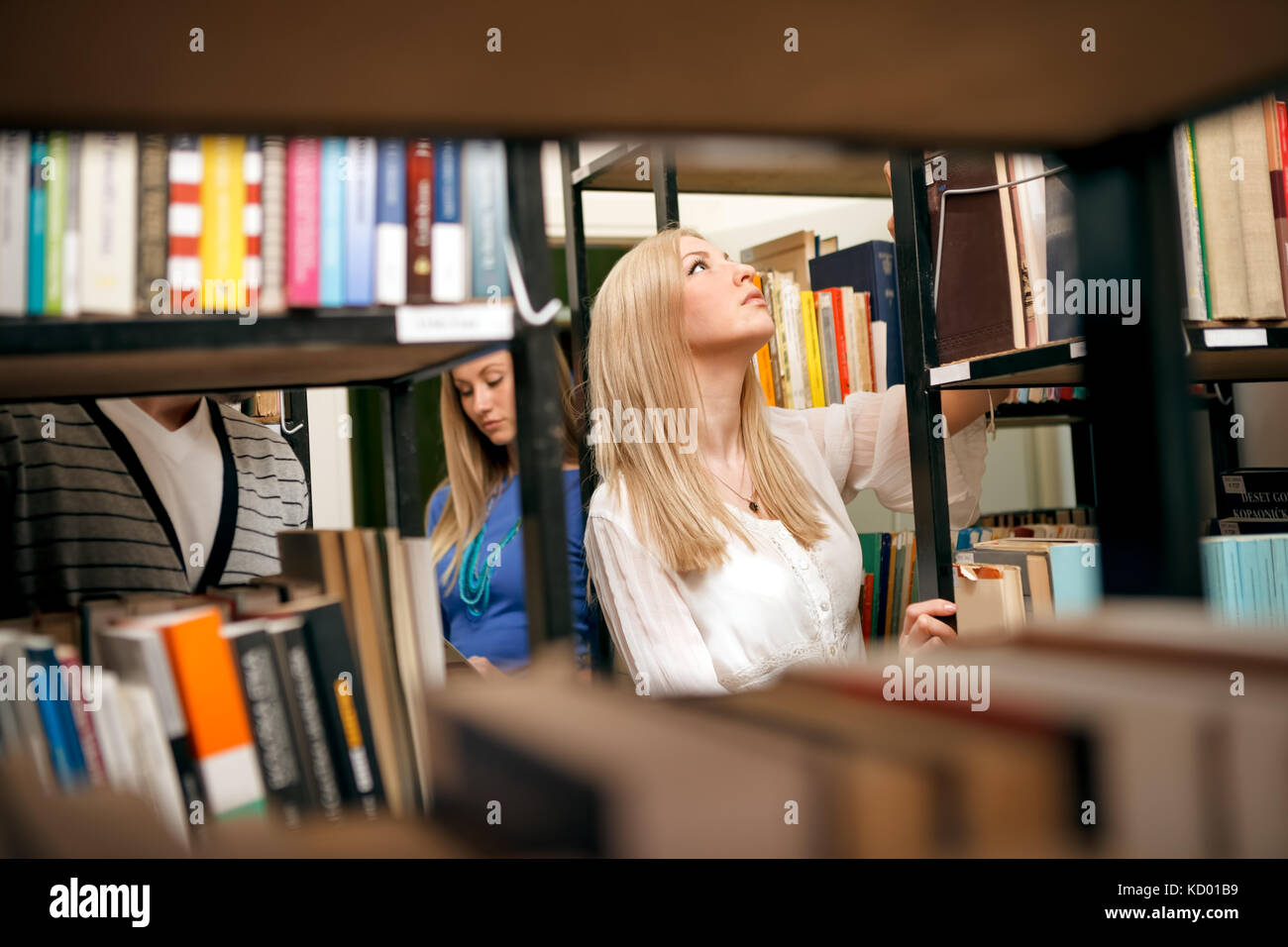 female student getting books in a library Stock Photo