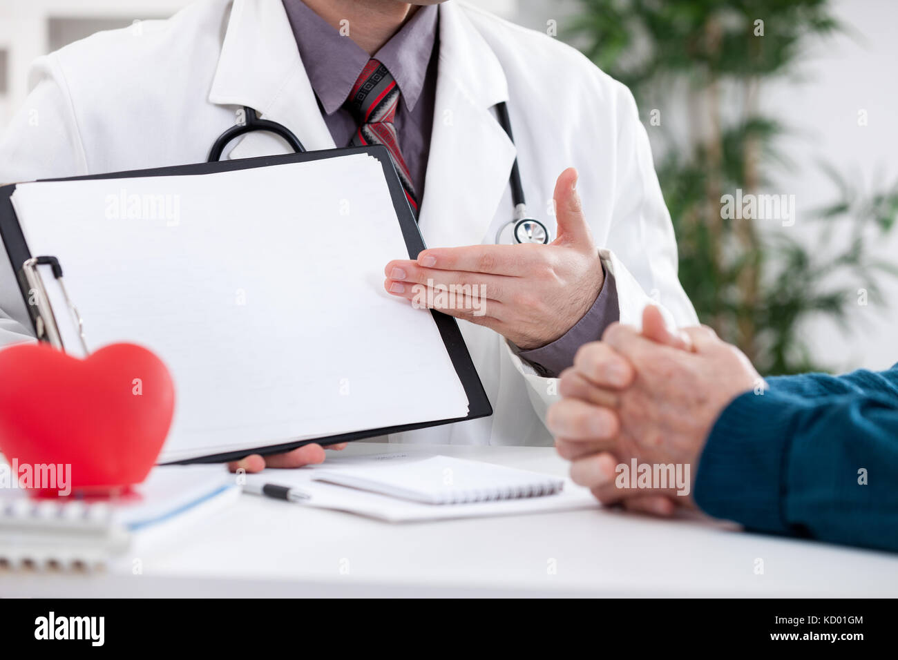 Cardiologist showing his patient EKG results Stock Photo