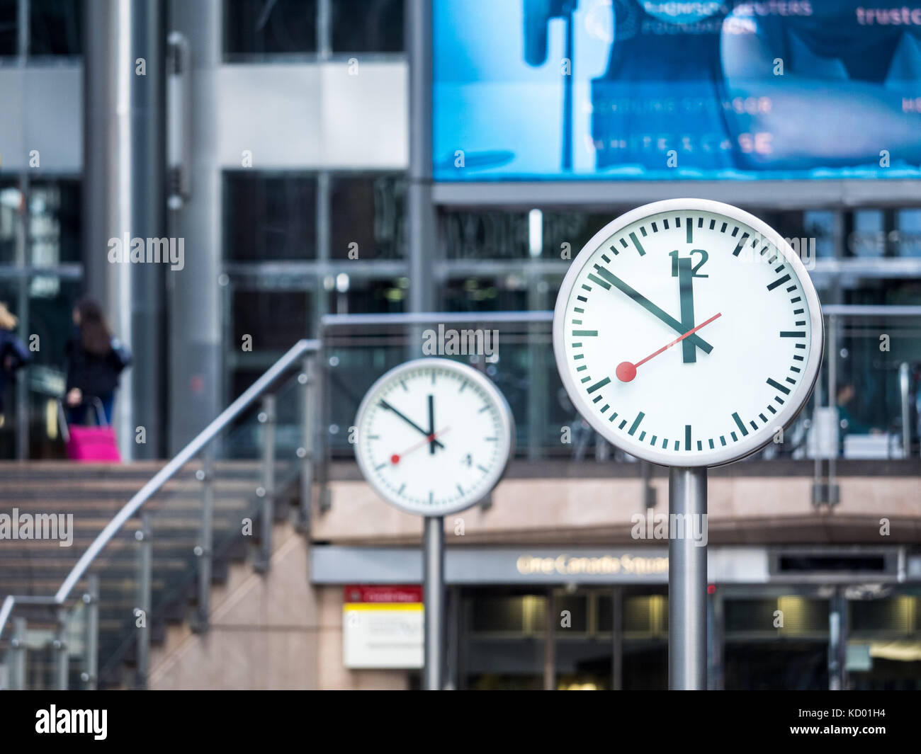 Clocks Canary Wharf Reuters Plaza - two of the Six Public Clocks artwork, by Konstantin Grcic, in Reuters Plaza Canary Wharf London UK Stock Photo