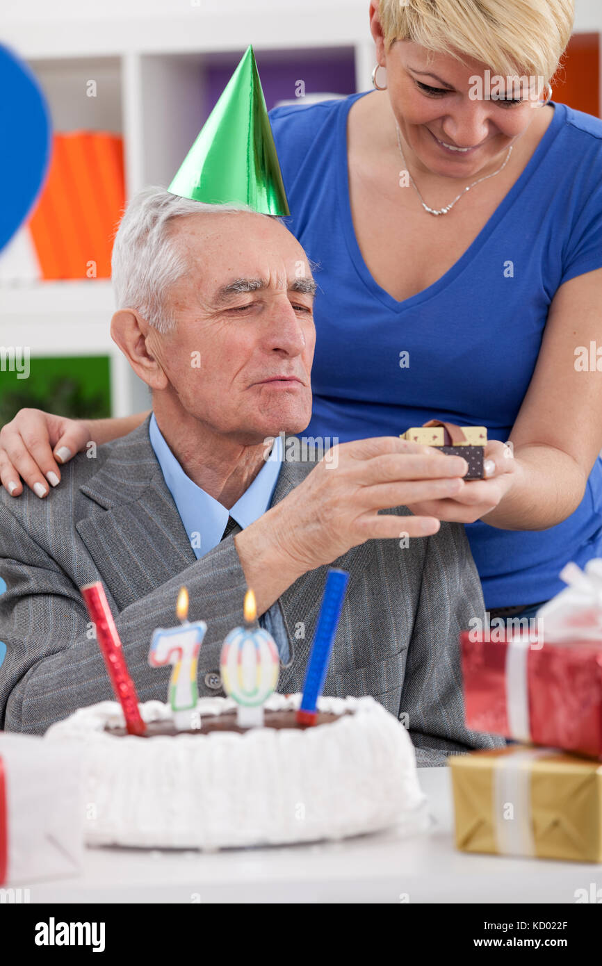 daughter gives father gift for 70th birthday Stock Photo