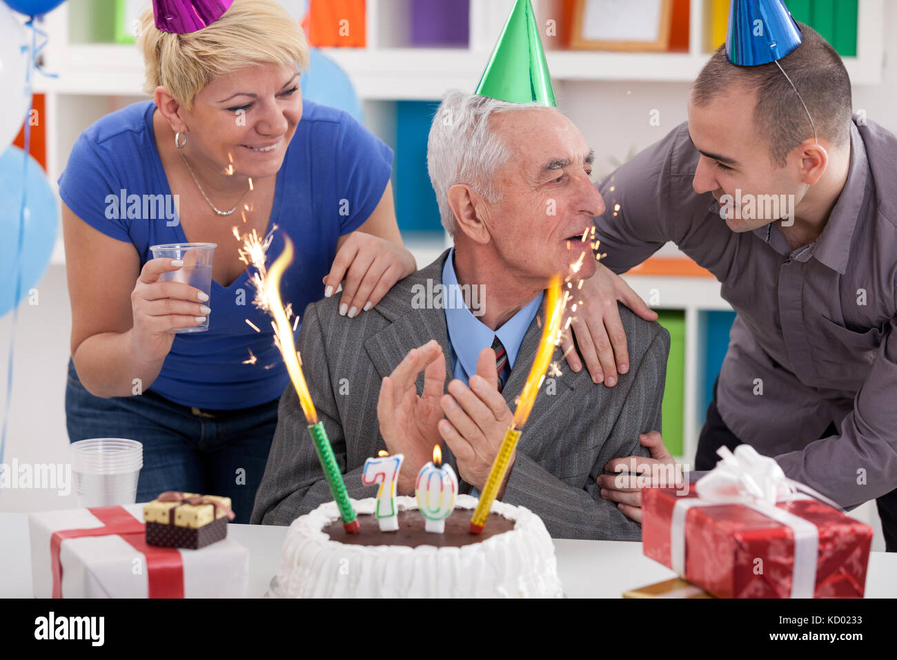 Party for 70th birthday, senior man celebrating birthday with his family Stock Photo