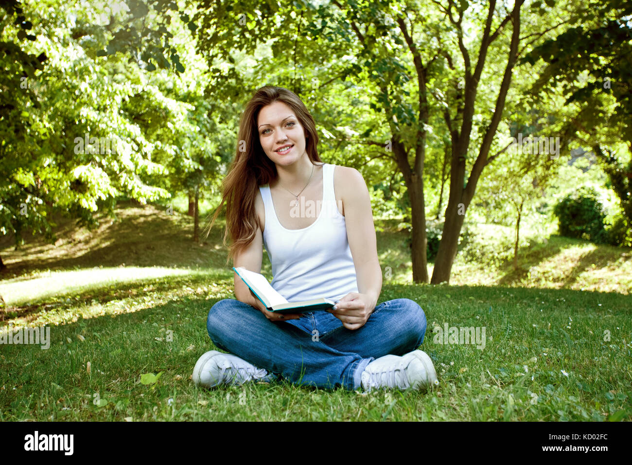 Young student girl with book in park Stock Photo - Alamy