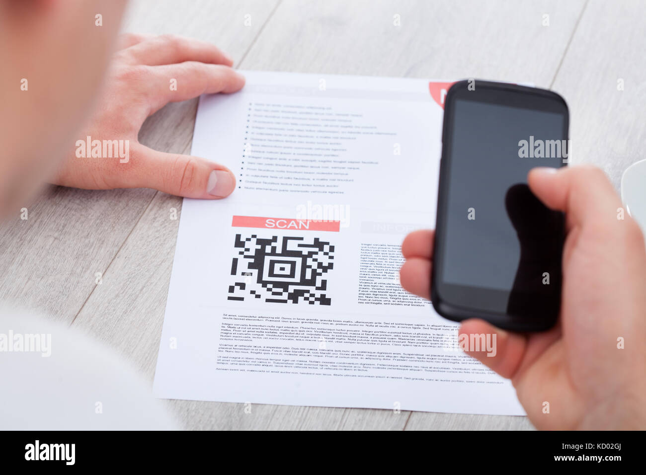Close-up Of Hand Holding Mobile Scanning Bar Code Stock Photo