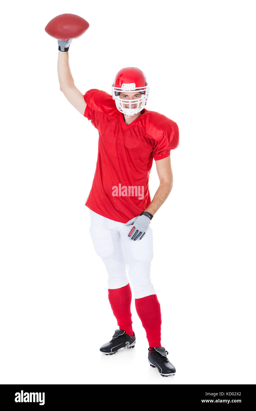 American Football Player Holding Rugby Ball On White Background Stock Photo