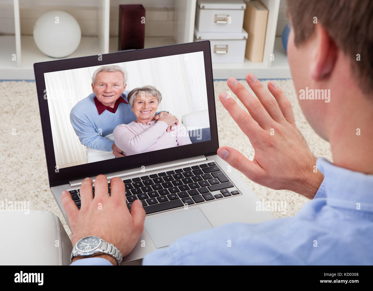 Close-up Of A Man Video Chatting On Laptop With His Parents Stock Photo