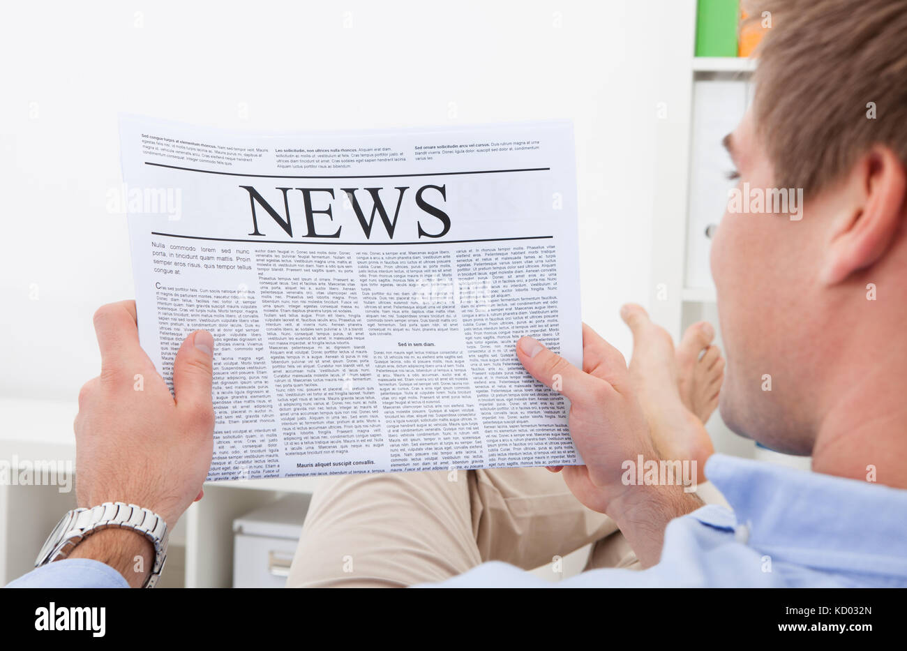 This newspaper reading. Человек читает газету со спины. Man reading newspaper. News stock image.