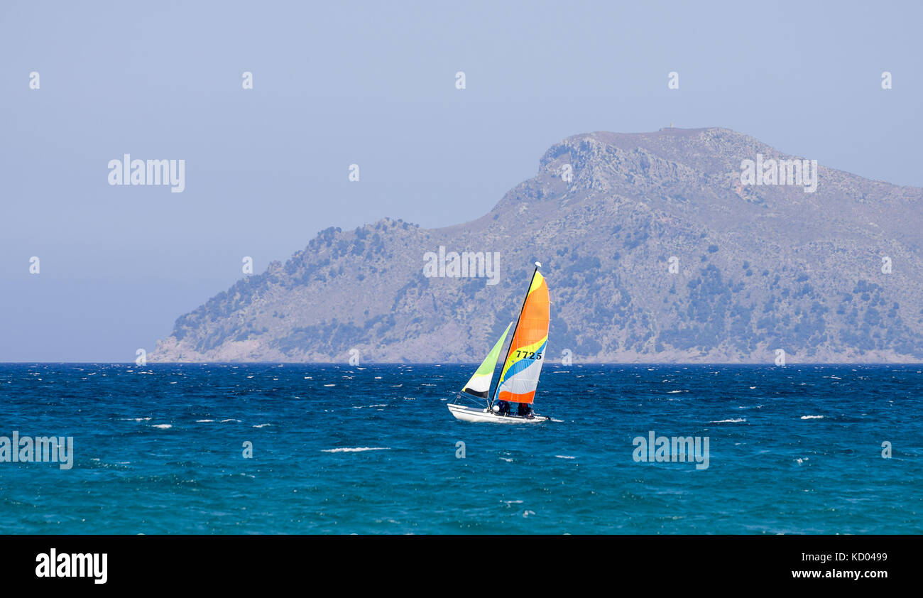 A small sailing boat in Alcudia bay near Can Picafort town, Majorca, Balearic islands Stock Photo
