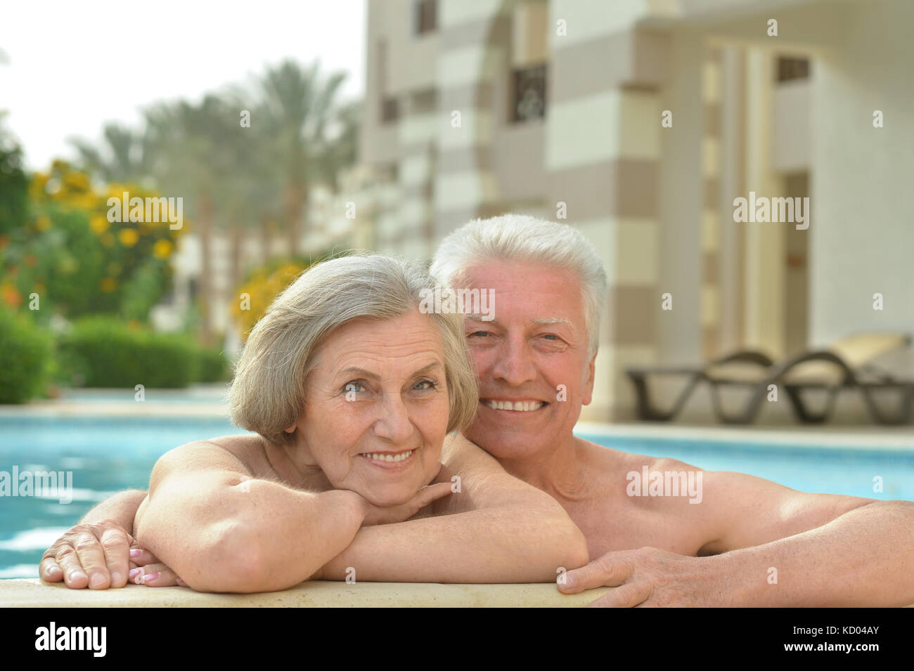 Senior couple relaxing at pool Stock Photo - Alamy