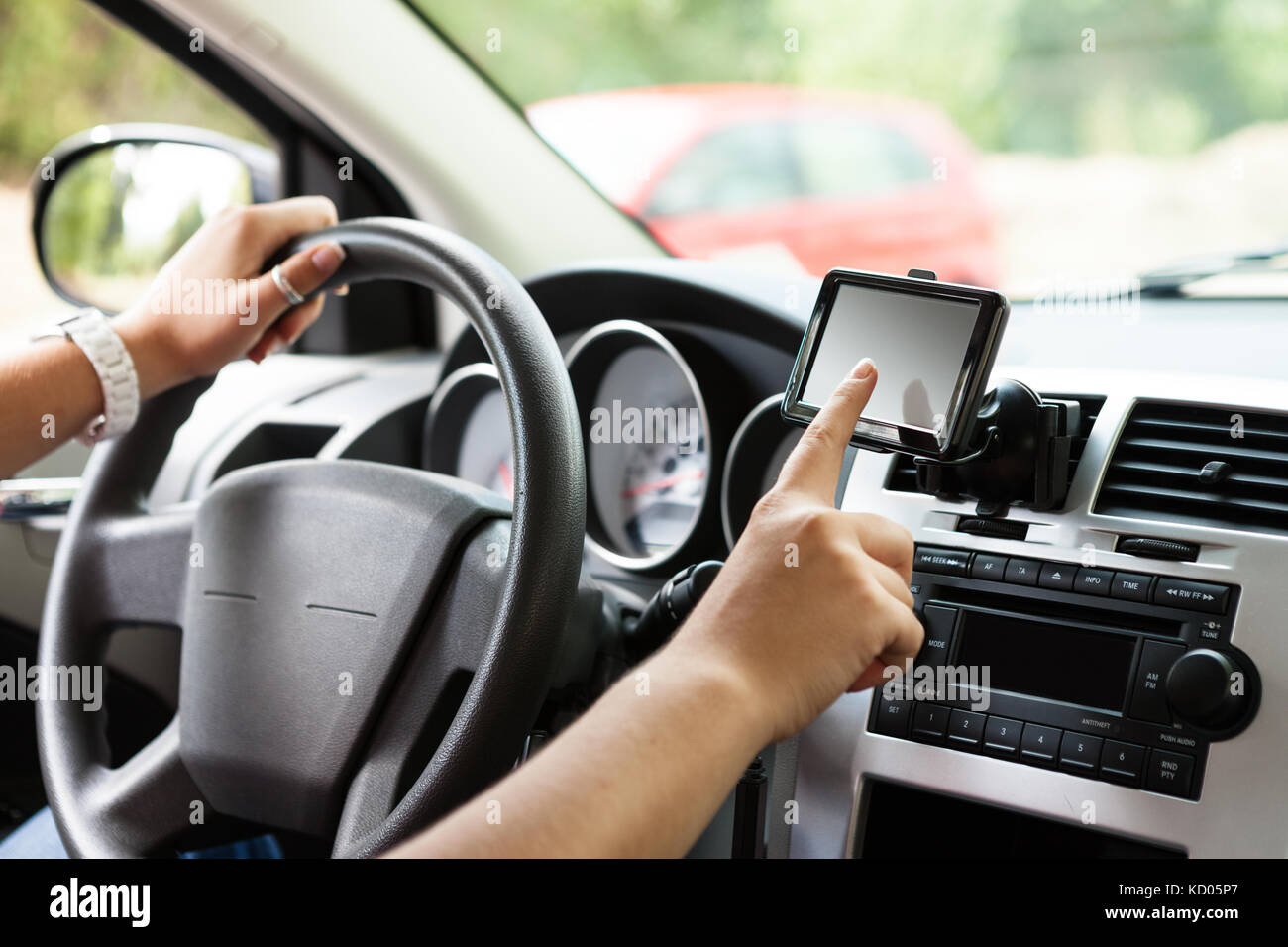 Driver setting navigation system while driving Stock Photo Alamy