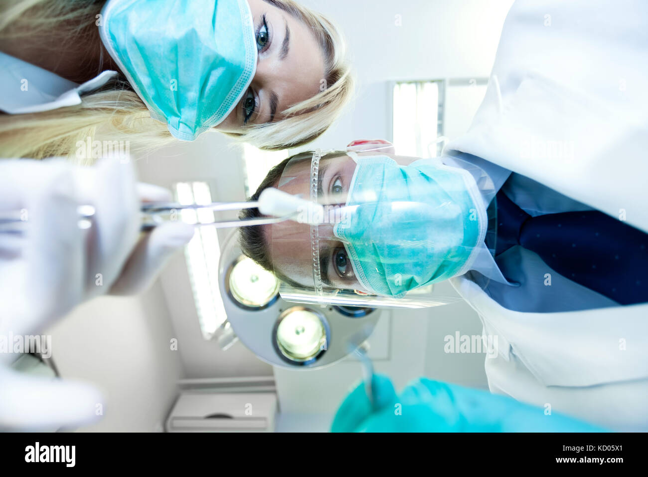 Dental team working with a patient in protective work wear Stock Photo