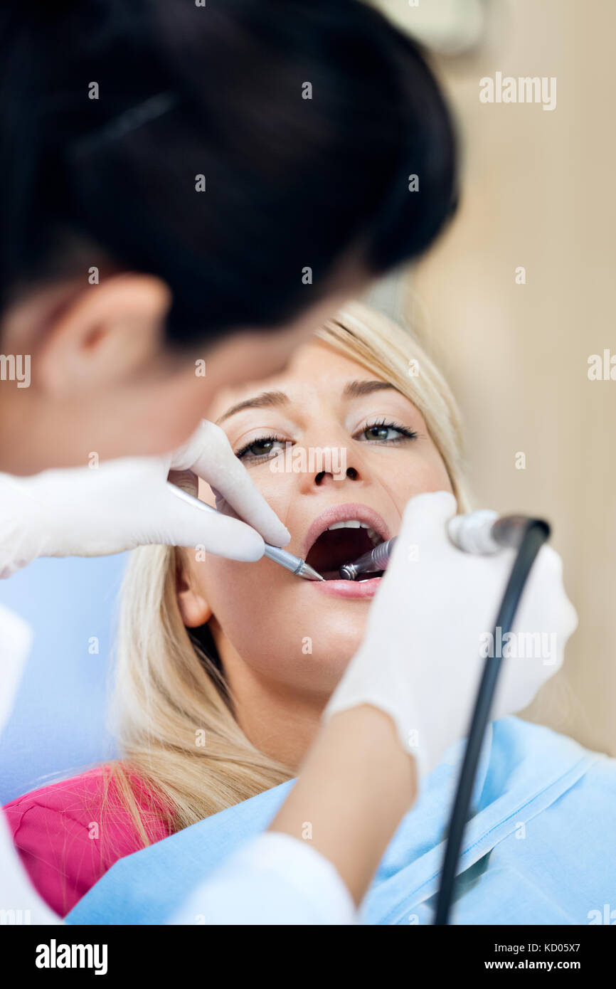 Young woman having her teeth polished by a dental hygienist Stock Photo