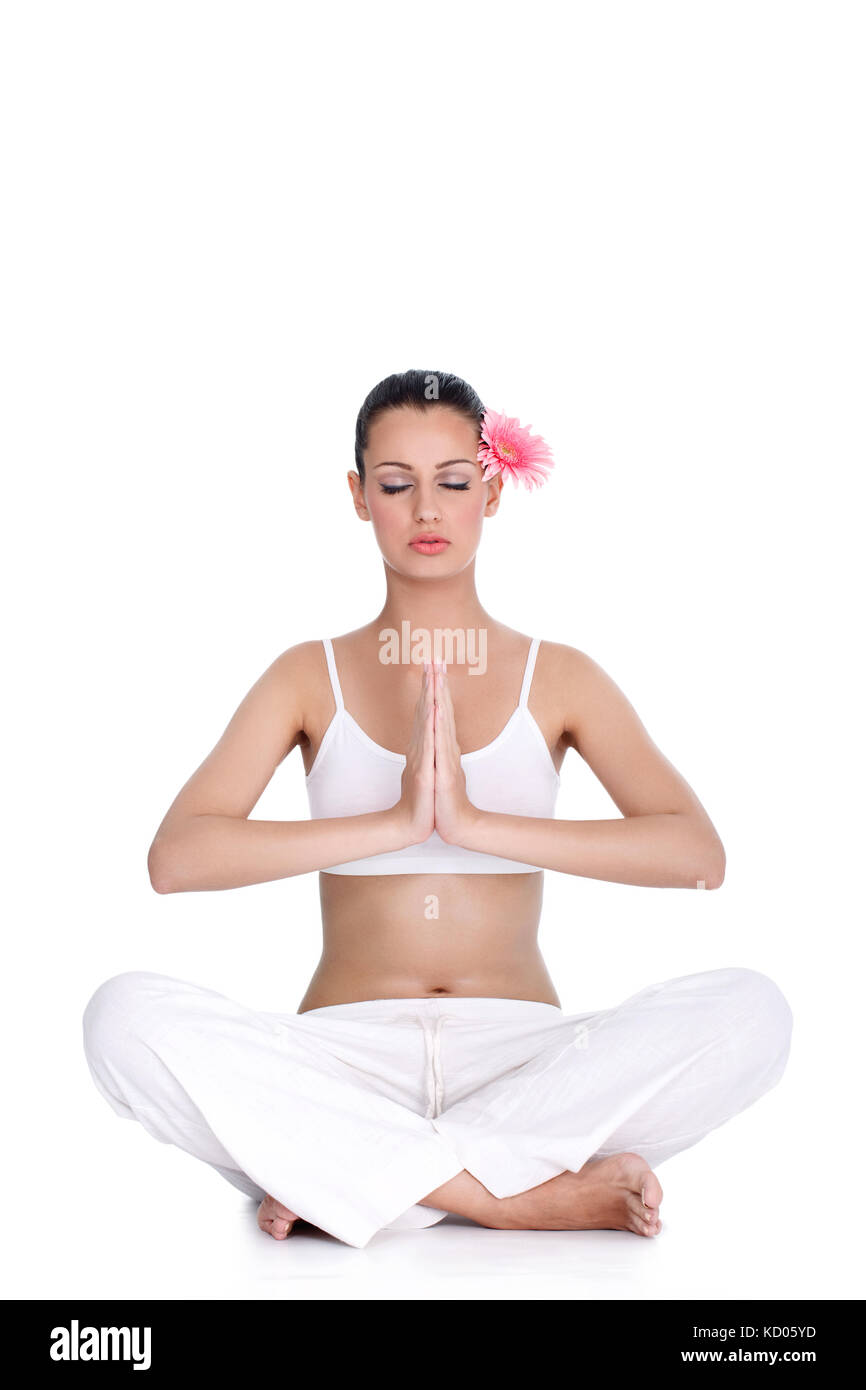 young tranquil woman meditating in lotus position Stock Photo