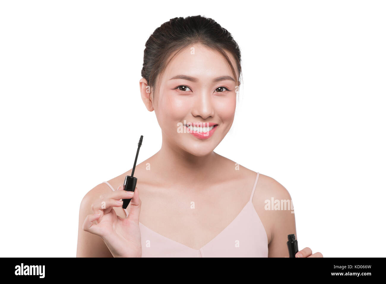 Eye make up apply.  Mascara brush. Portrait of beautiful asian woman with perfect fresh face skin. Stock Photo