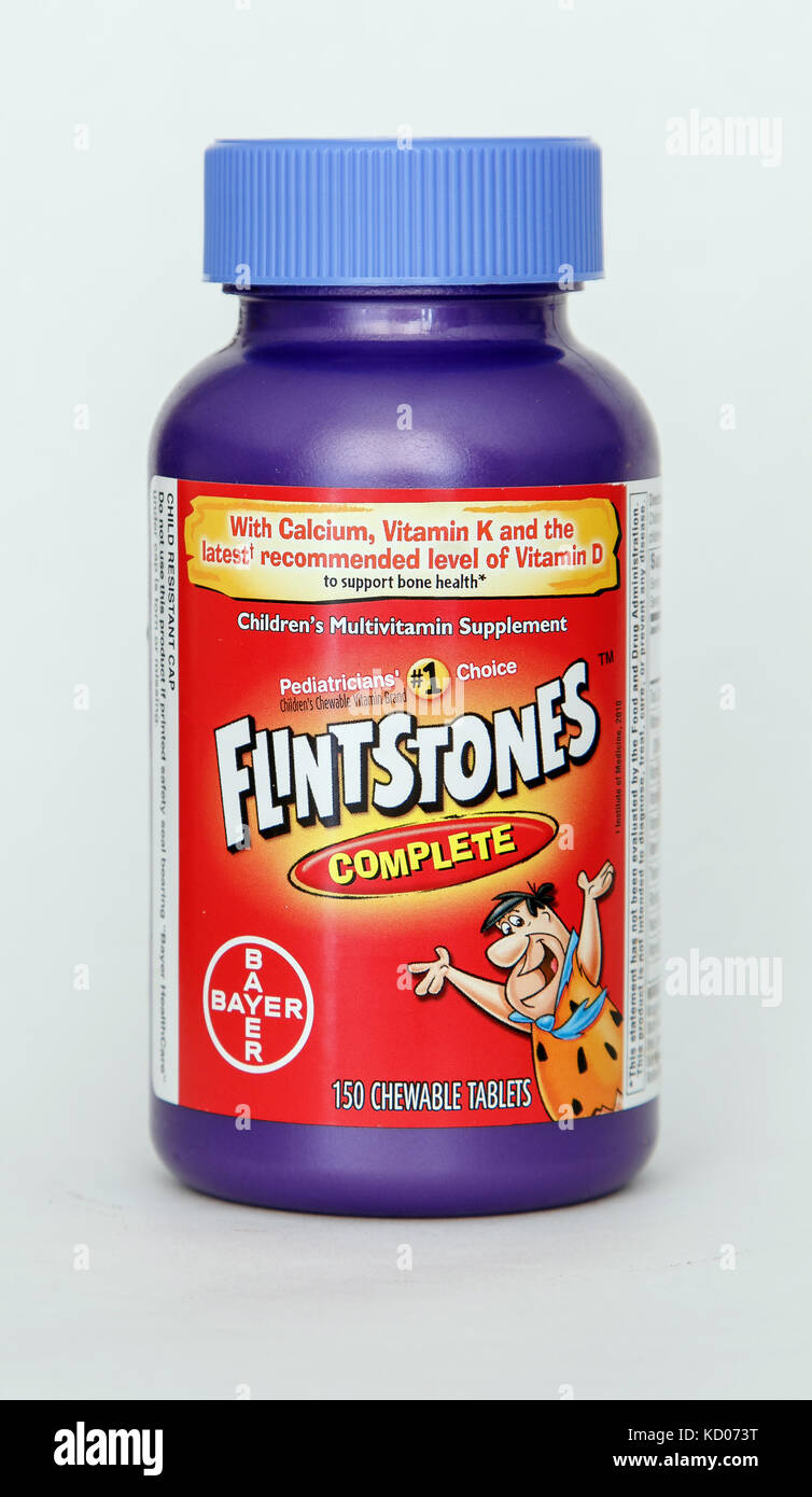 Bottle of Flintstones children's vitamins stands against white background. Stock Photo