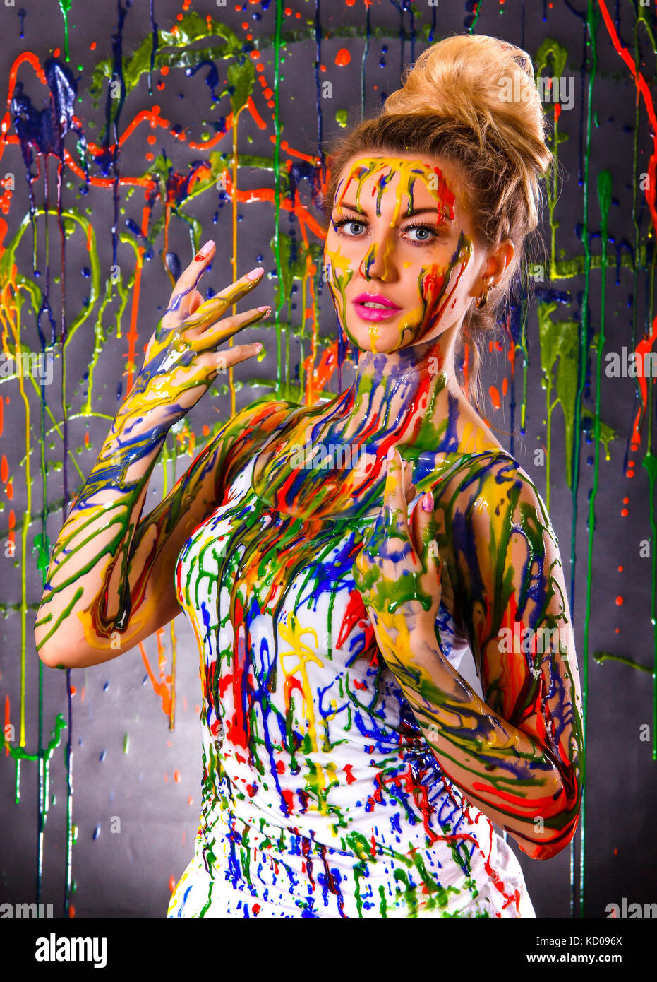 Beautiful young woman covered with multicolored paints Stock Photo