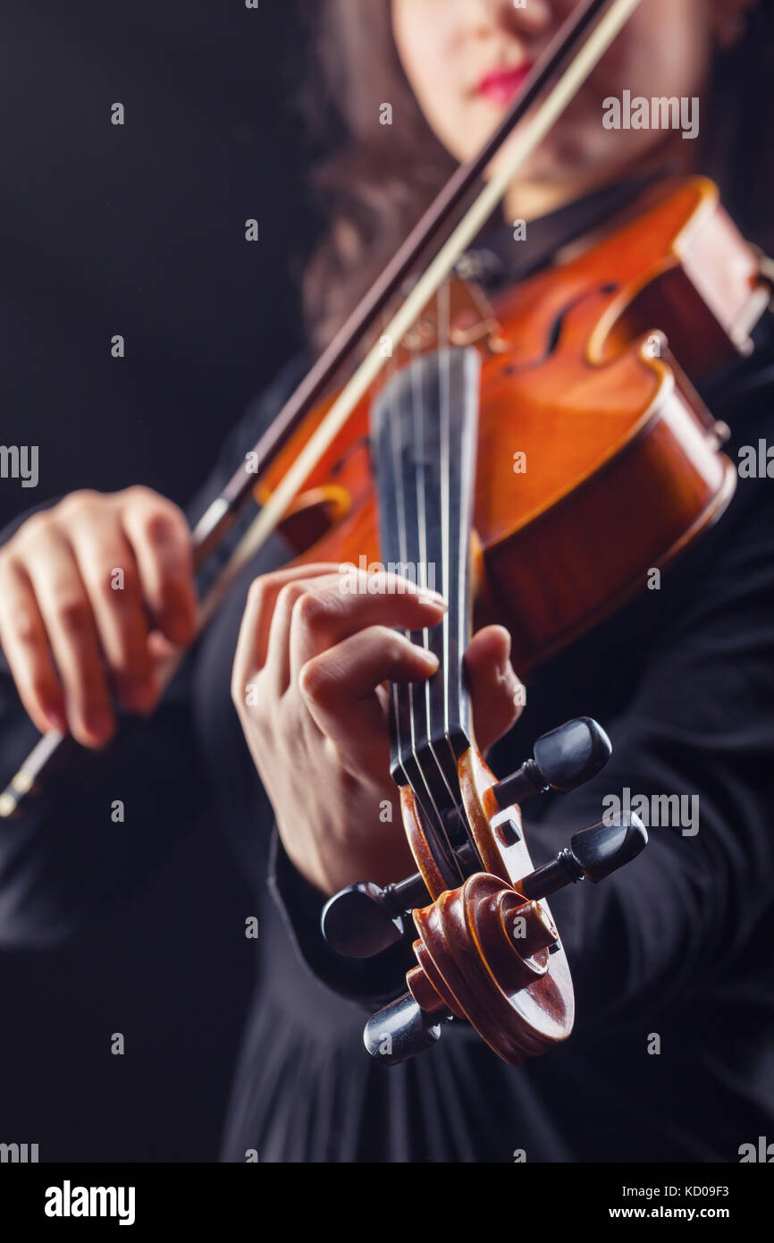 Musical concept. A woman is playing the violin. Focus on the violin Stock Photo