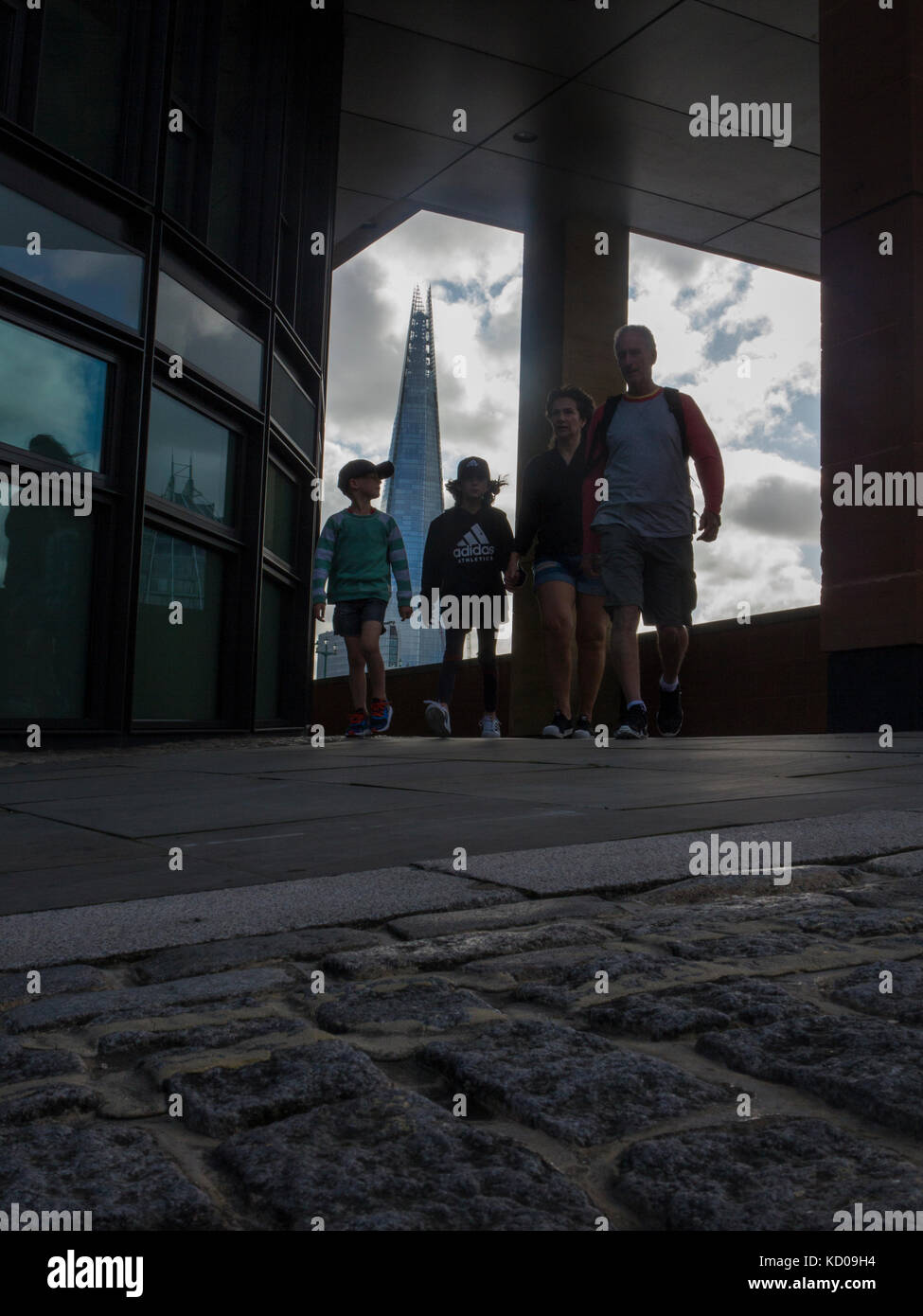 An unusual view of the Shard from the North Embankment with people walking, holding hands Stock Photo