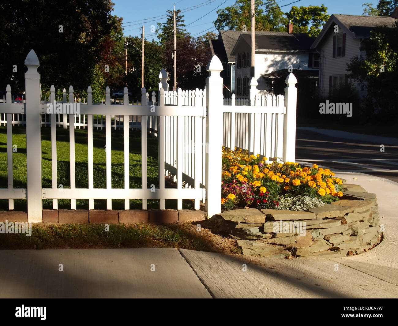 residential picket fence on the corner of a small town street Stock Photo