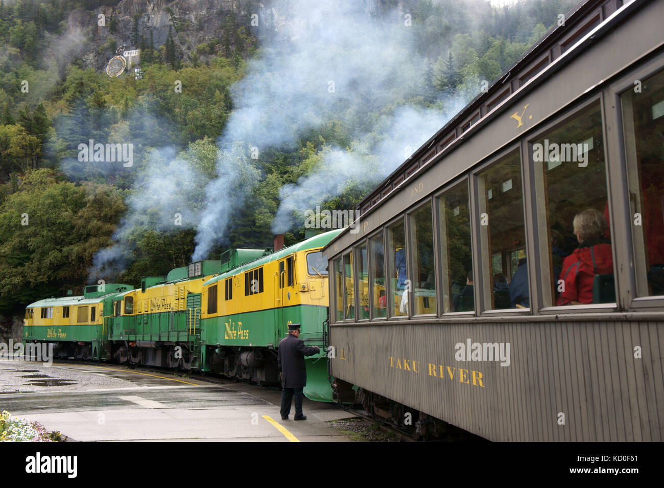 White Pass railroad trin with diesel engines and historic passenger car leaving staion at Skagway, Alaska Stock Photo