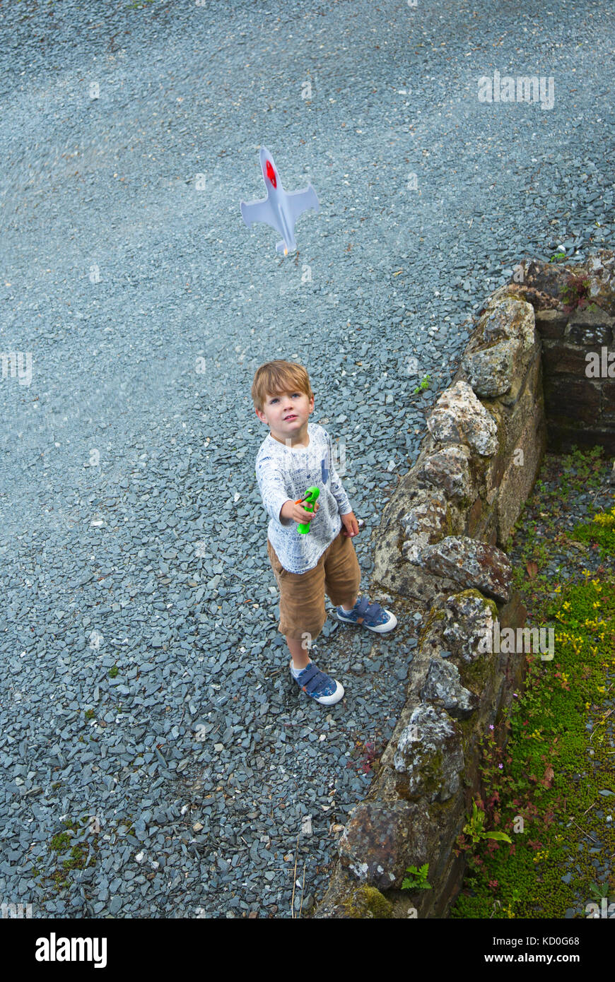 A small boy playing with his toy plane Stock Photo - Alamy
