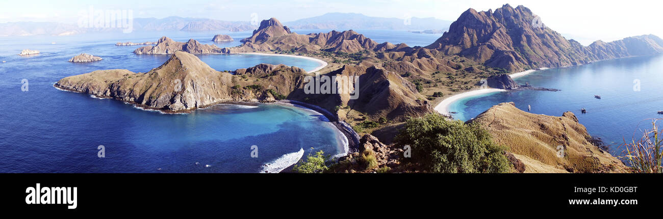 High Panoramic scenic view of Padar Island with  three beautiful bays and sandy beaches surrounded by a wide ocean and part of komodo national park in Stock Photo