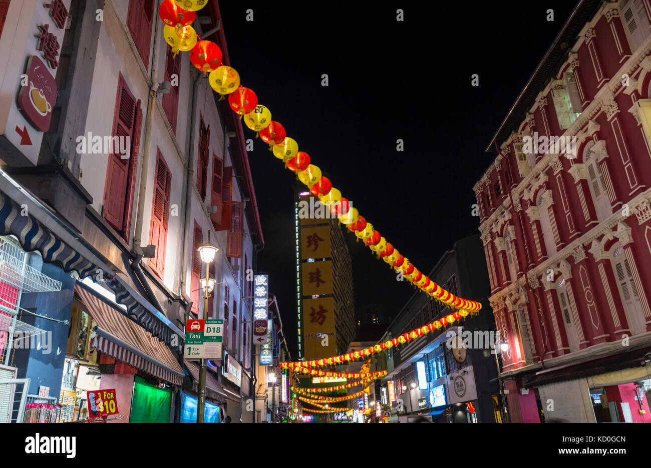 Paper lanterns and shopfronts in chinatown street at night, Singapore, South East Asia Stock Photo