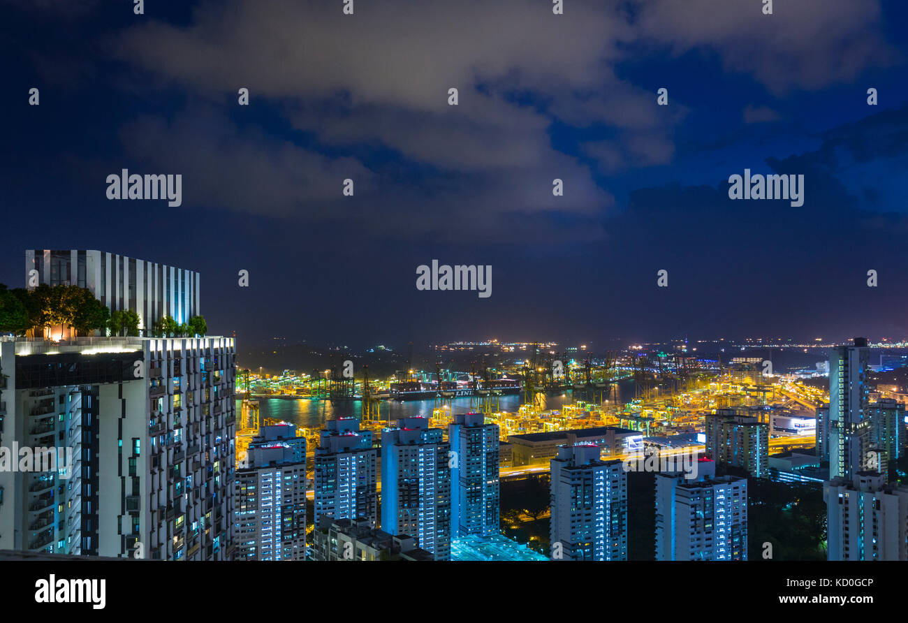 Elevated cityscape with modern apartments and city lights at night, Singapore, South East Asia Stock Photo