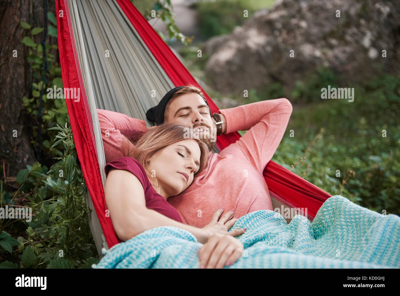 Couple relaxing in hammock, eyes closed sleeping, Krakow, Malopolskie, Poland, Europe Stock Photo