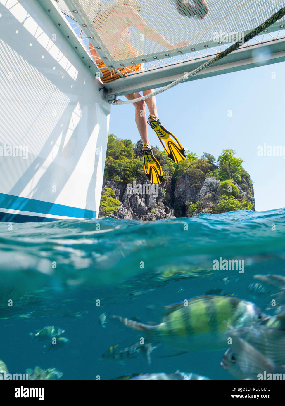 Legs of woman dangling from yacht, Koh Pak Ka, Krabi, Thailand, Asia Stock Photo