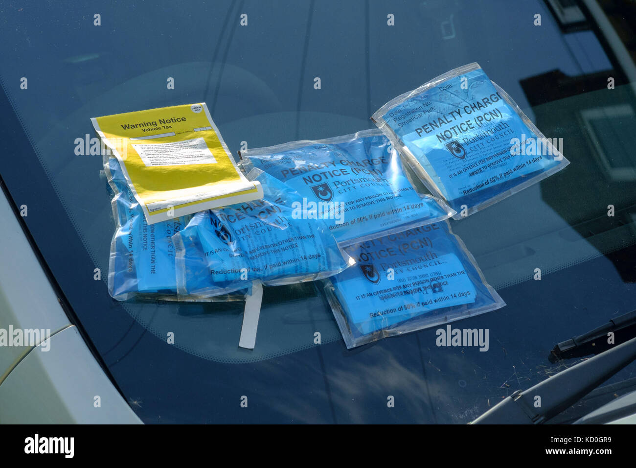 a car windscreen covered with multiple parking tickets and penalty notices england uk Stock Photo