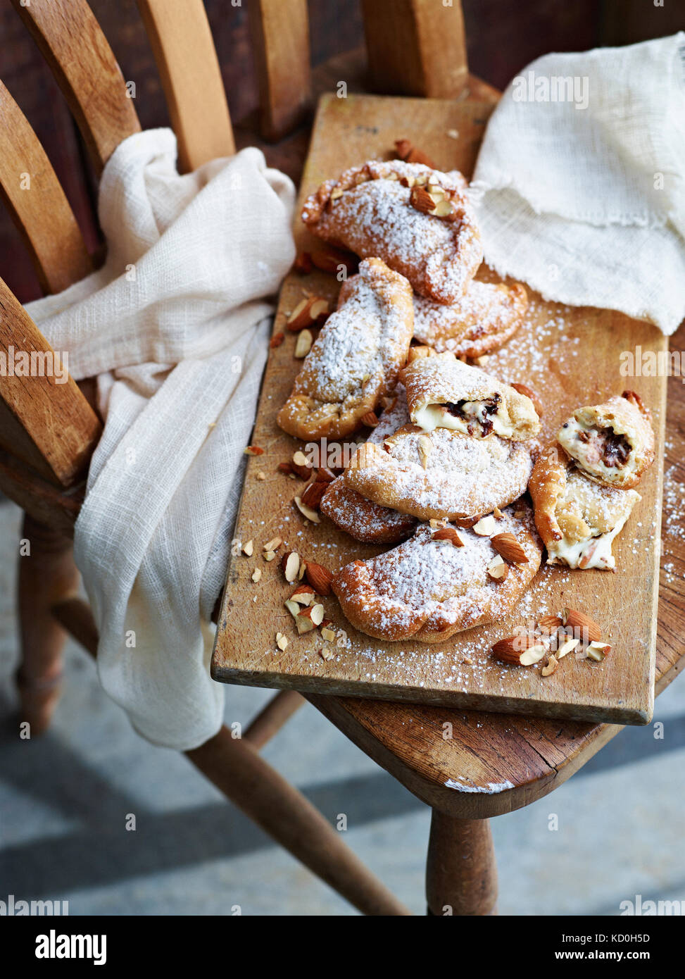 Cannoli calzone dusted with sugar, on serving board Stock Photo - Alamy