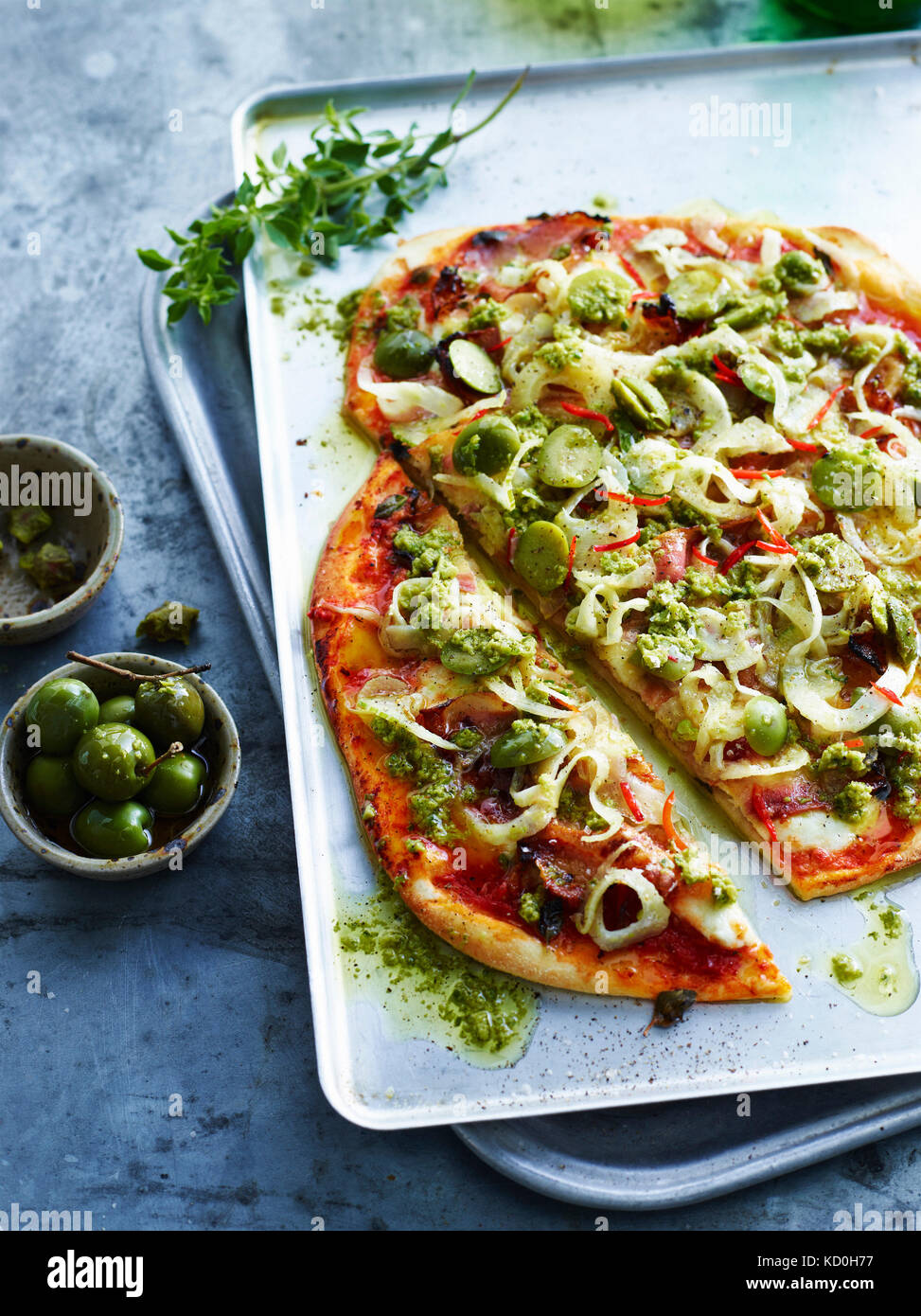 Sliced guancaille and green olive pizza, close-up Stock Photo