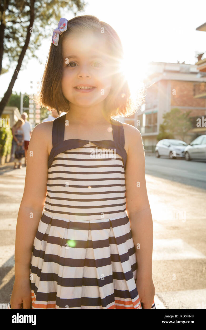 Portrait of girl in street looking at camera smiling Stock Photo