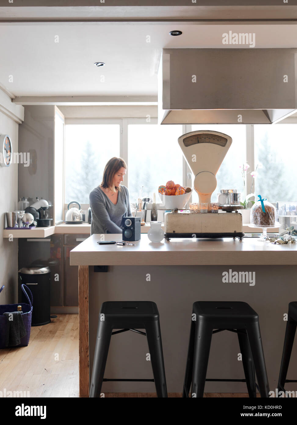 Woman standing kitchen stool hi-res stock photography and images - Alamy