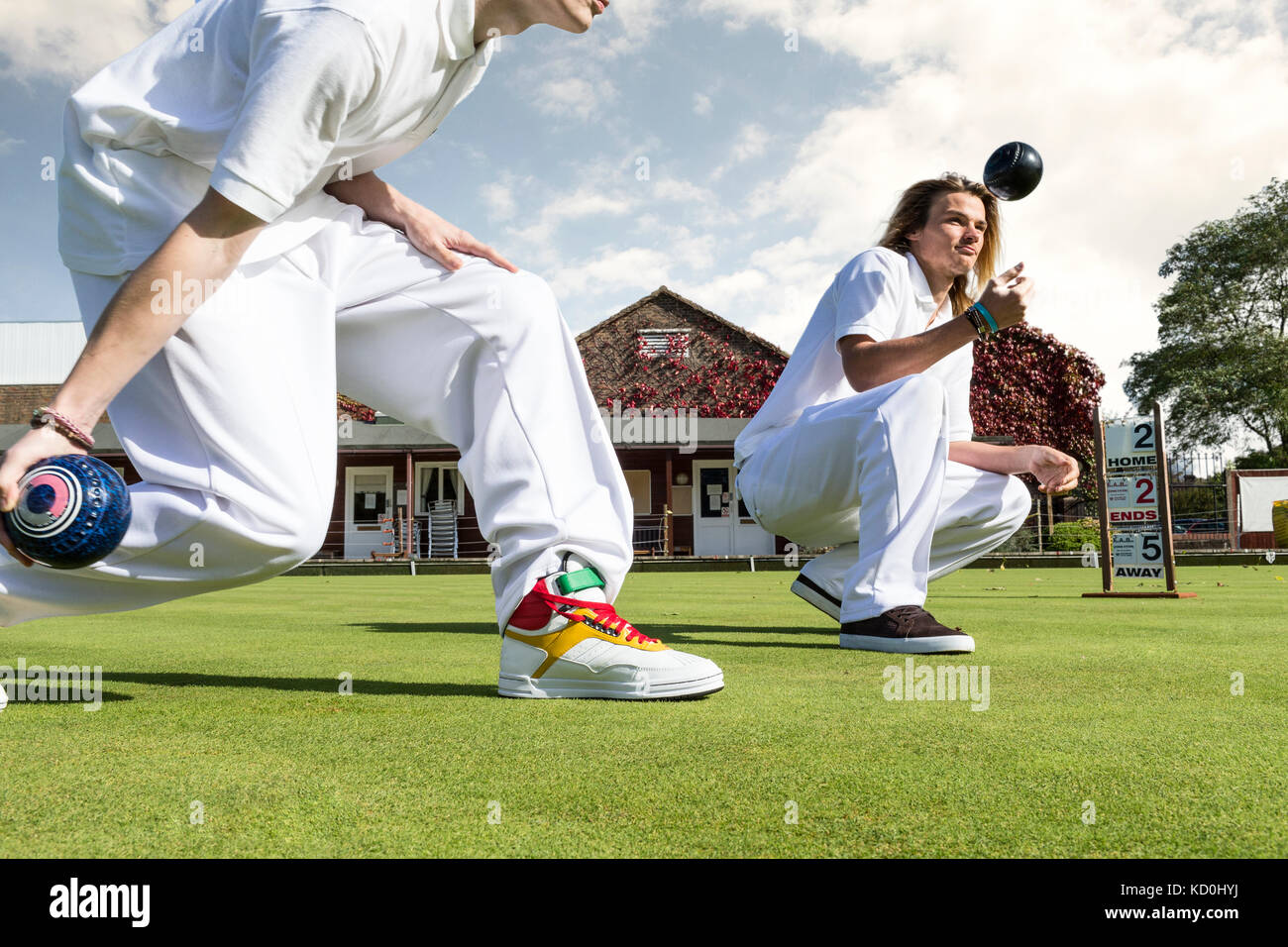 Cropped shot of two young men lawn bowling on bowling green Stock Photo