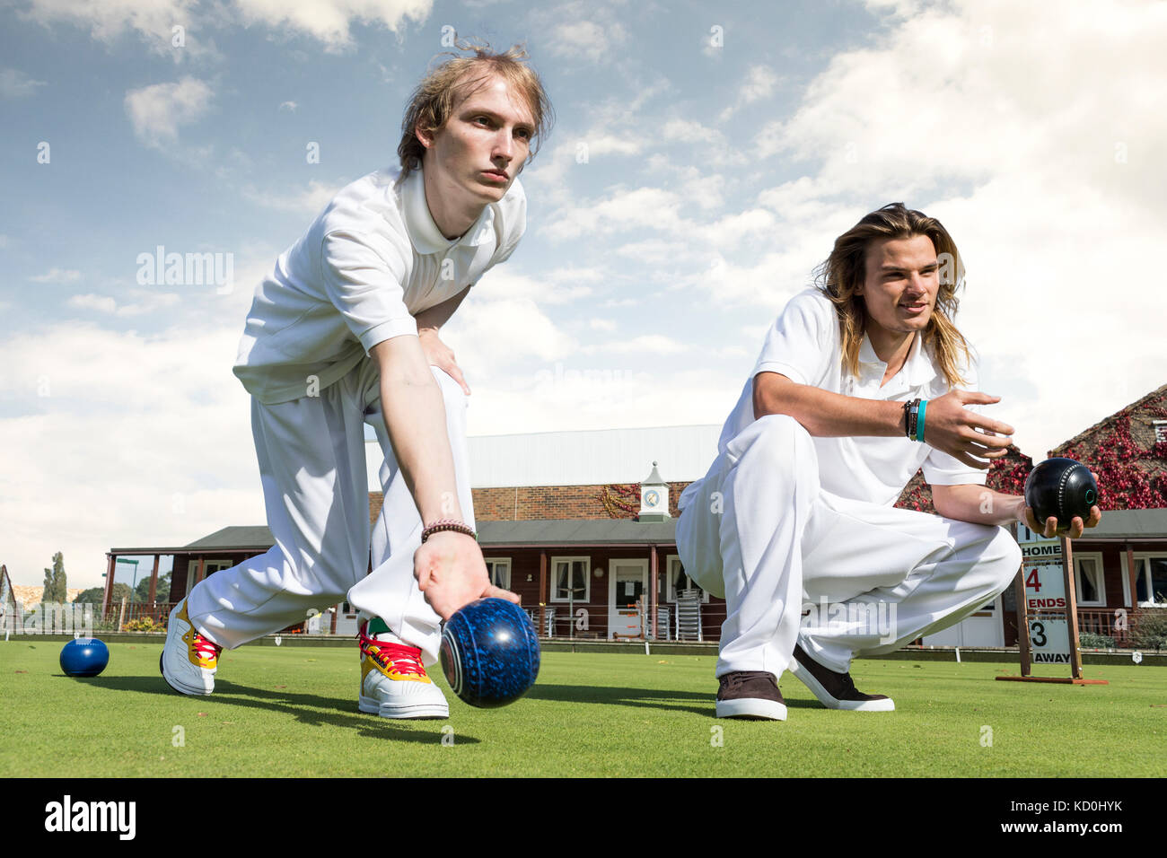 Two young men lawn bowling on bowling green Stock Photo