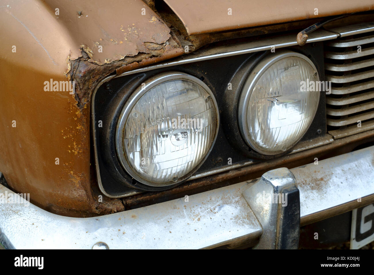 a barn find of a british sunbeam rapier car from the 1970s ready for restoration as a project showing corrosion around headlights on front wing Stock Photo