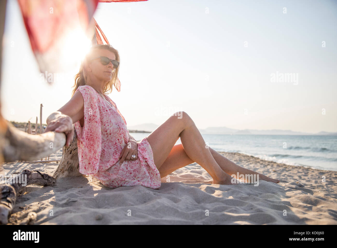 Woman sitting on beach relaxing, Palma de Mallorca, Islas Baleares, Spain, Europe Stock Photo