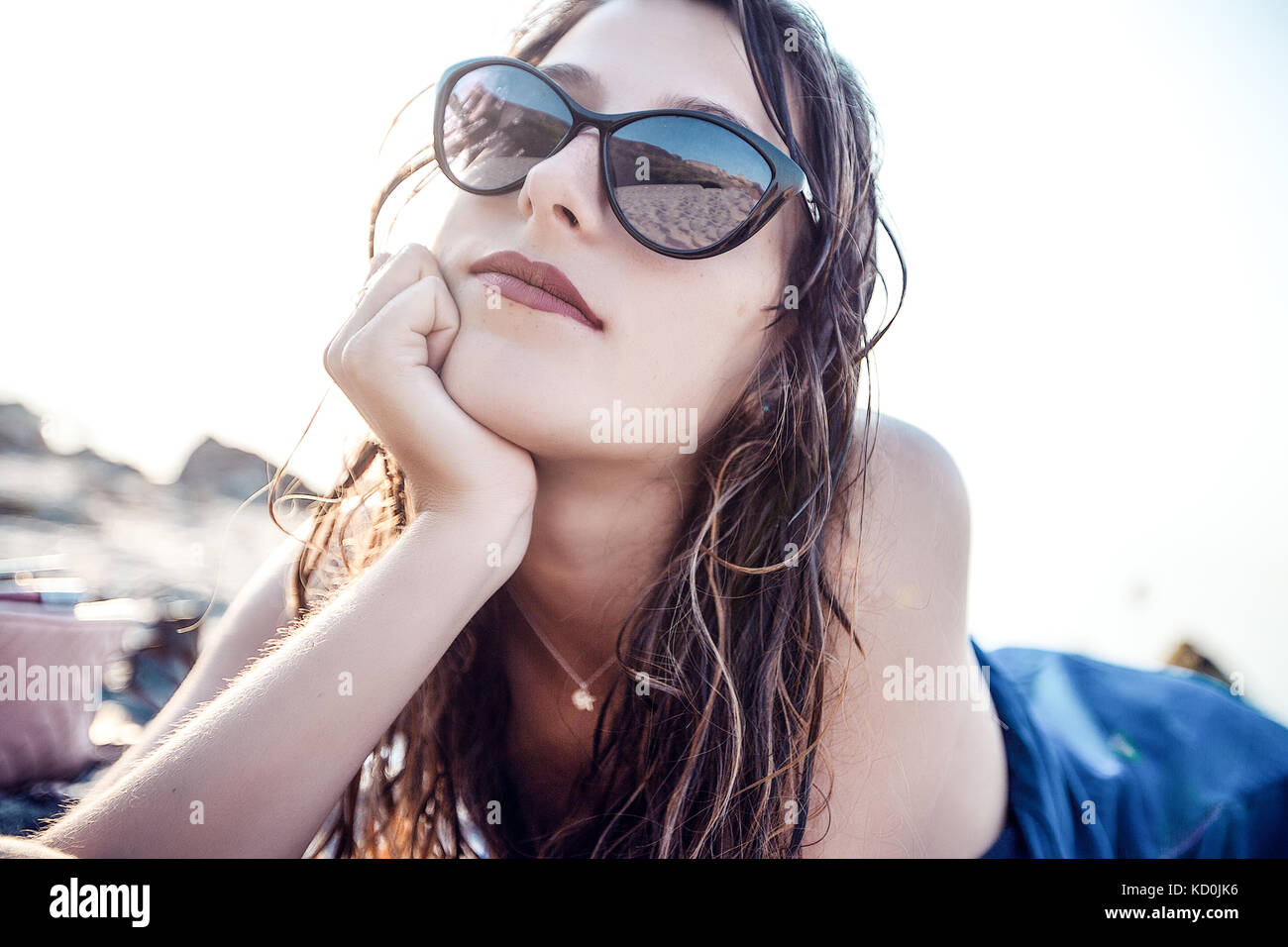 Portrait of young woman in shades on beach, Odessa, Ukraine Stock Photo