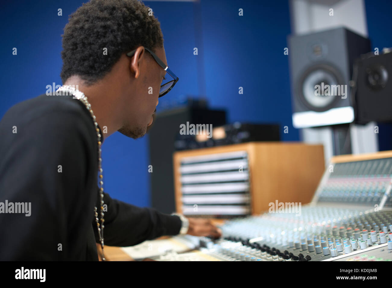Young male college student at sound mixer in recording studio Stock ...